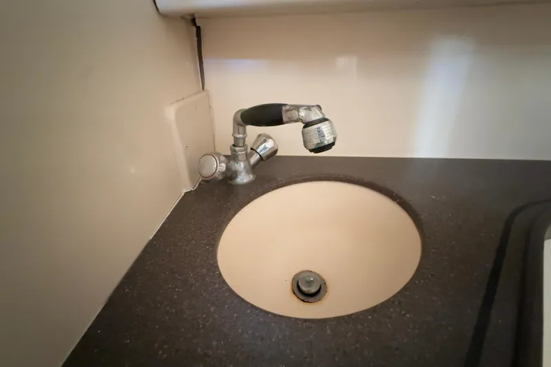 Slide: The Image of 2005 Grady-White Express 330 boat sink with faucet in cabin interior. - 30