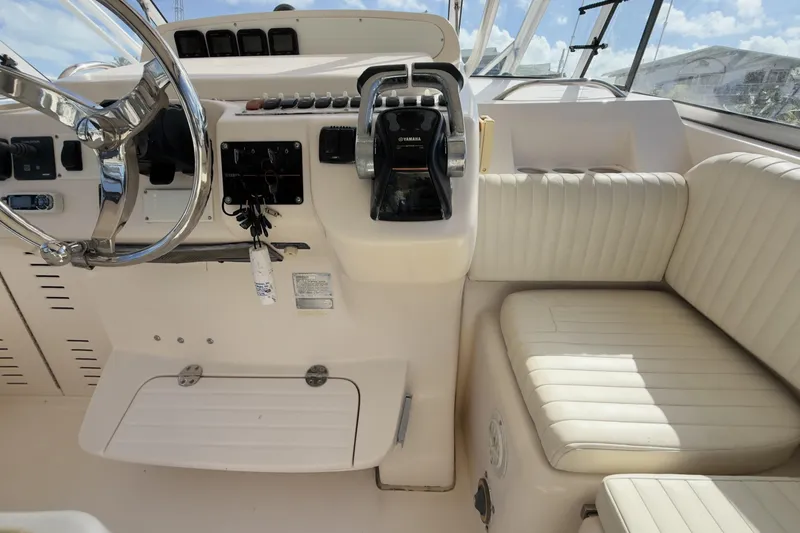 Slide: The Image of 2005 Grady-White Express 330 helm with steering wheel and control panel. - 34