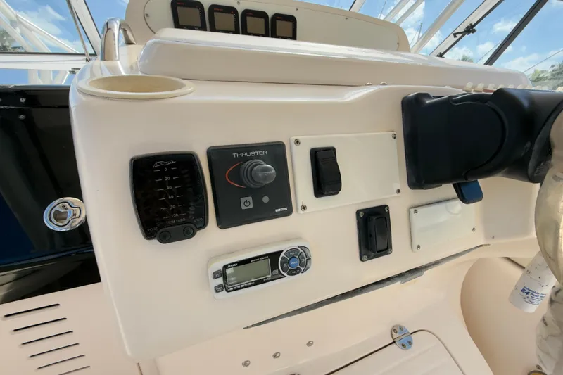 Slide: The Image of Control panel of a 2005 Grady-White Express 330 boat with various switches and gauges. - 37