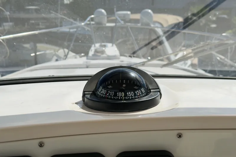 Slide: The Image of Compass on 2005 Grady-White Express 330 boat dashboard, with windshield view. - 39