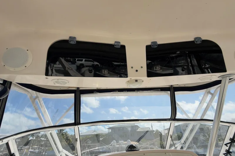 Slide: The Image of 2005 Grady-White Express 330 boat interior with clear view of the helm and overhead compartments. - 40