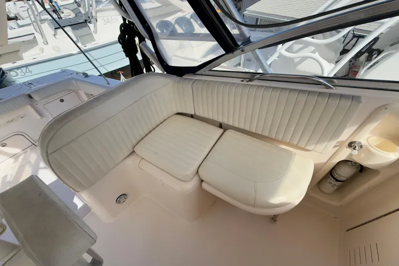 Slide: The Image of 2005 Grady-White Express 330 boat interior with white cushioned seating. - 41