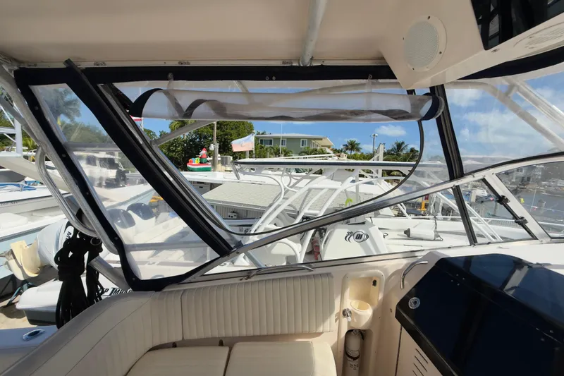 Slide: The Image of 2005 Grady-White Express 330 boat interior with clear enclosure and marina view. - 42