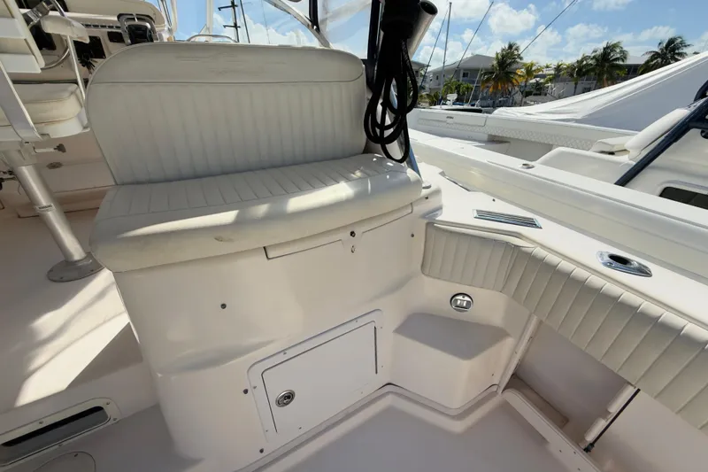 Slide: The Image of 2005 Grady-White Express 330 boat interior with cushioned seating and storage. - 44