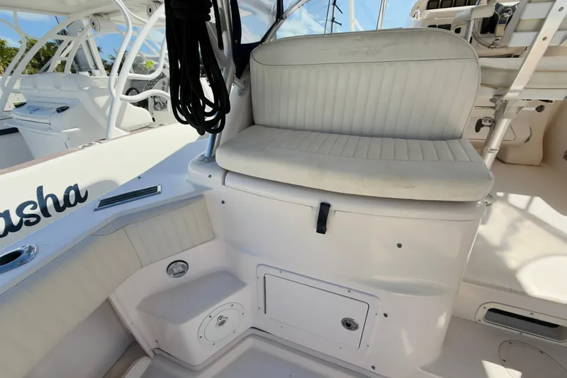 Slide: The Image of 2005 Grady-White Express 330 boat interior with cushioned seating and storage compartments. - 45