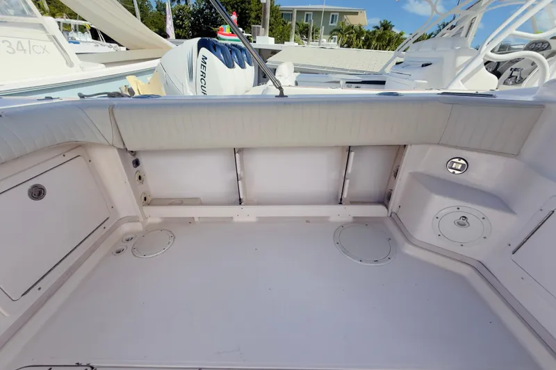 Slide: The Image of 2005 Grady-White Express 330 boat interior with Mercury engine, spacious deck area. - 49