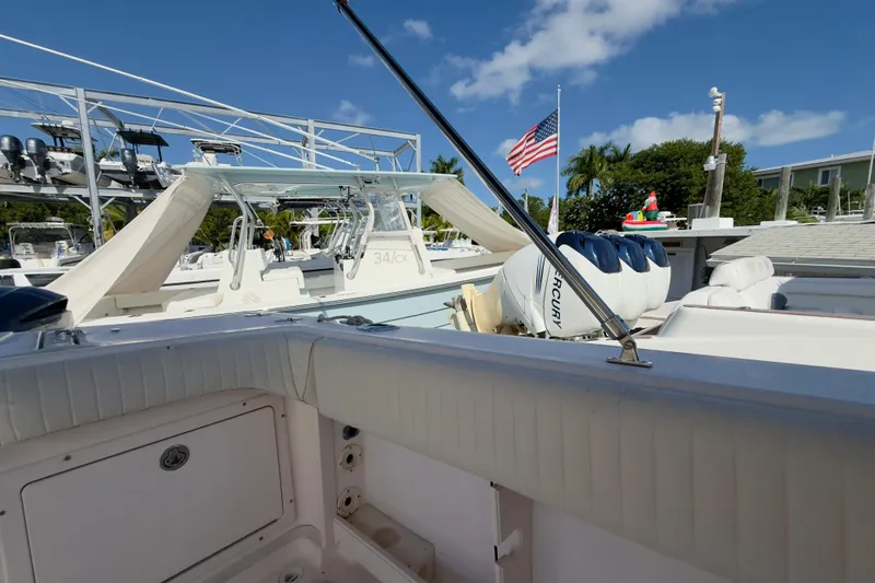 Slide: The Image of 2005 Grady-White Express 330 boat docked, featuring Mercury engines and American flag. - 56