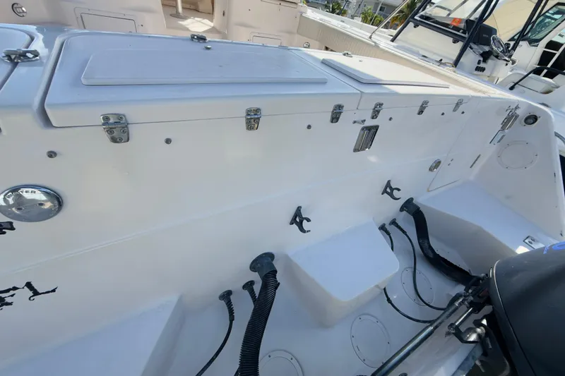 Slide: The Image of 2005 Grady-White Express 330 boat deck with storage compartments and fishing rod holders. - 59