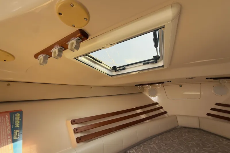 Slide: The Image of 2005 Grady-White Express 330 cabin interior with skylight and wooden accents. - 6