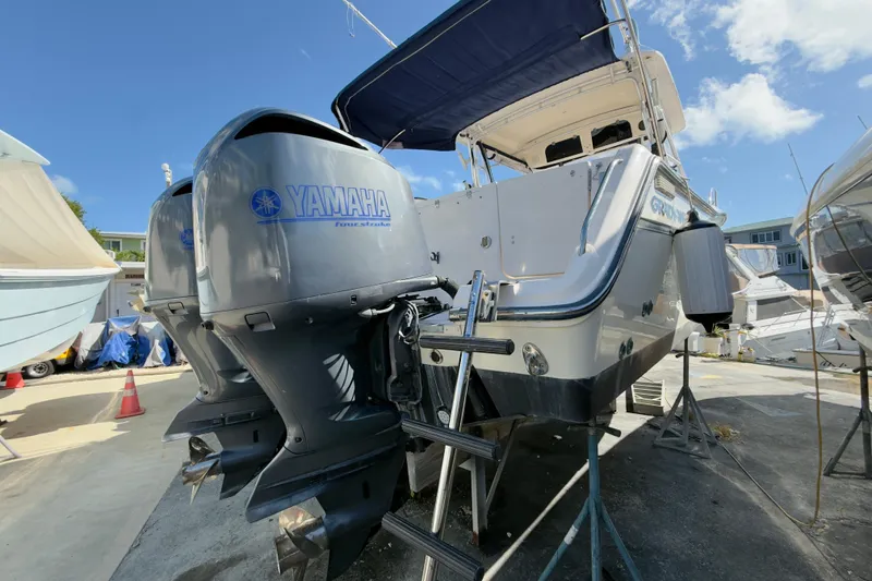 Slide: The Image of 2005 Grady-White Express 330 boat with Yamaha engines, docked under clear blue sky. - 62