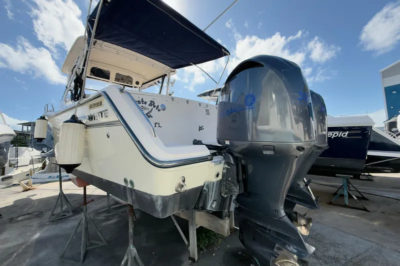 Slide: The Image of 2005 Grady-White Express 330 boat with dual outboard motors on a sunny day. - 63