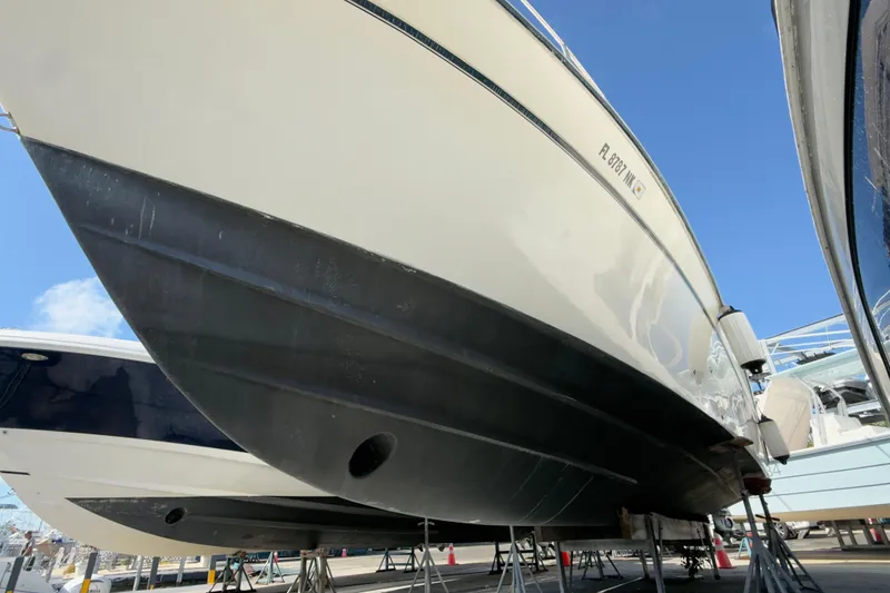 Slide: The Image of 2005 Grady-White Express 330 boat on stands, viewed from below, clear sky background. - 67