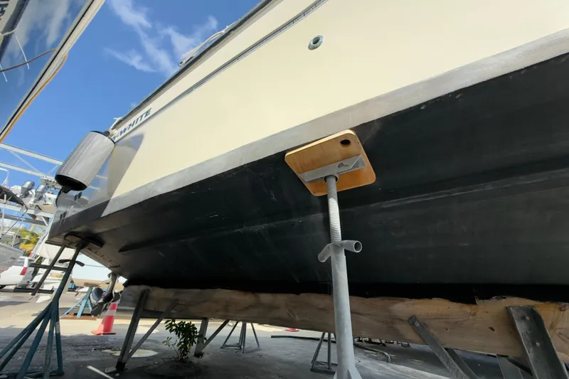 Slide: The Image of 2005 Grady-White Express 330 boat on dry dock, underside view with support stands. - 69