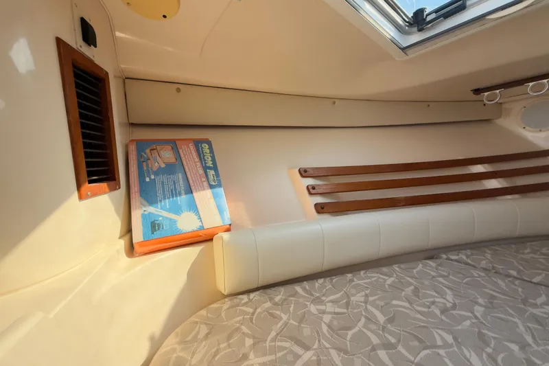 Slide: The Image of 2005 Grady-White Express 330 cabin interior with seating and storage. - 7
