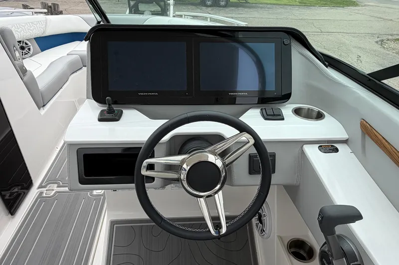 Slide: The Image of 2026 Regal LS9 Surf boat dashboard with dual screens and steering wheel. - 13
