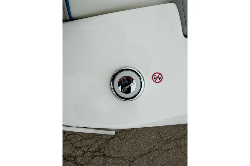 Slide: The Image of Fuel cap of 2026 Regal LS9 Surf boat with warning sticker on white surface. - 18
