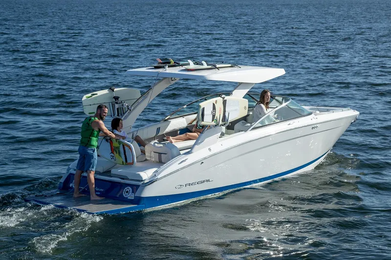Slide: The Image of Manufacturer Provided Image: 2026 Regal LS9 Surf boat cruising on open water with passengers enjoying the ride. - 2