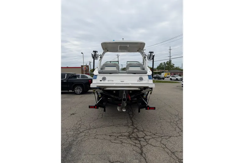 Slide: The Image of 2026 Regal LS9 Surf boat on trailer, rear view in parking lot. - 21