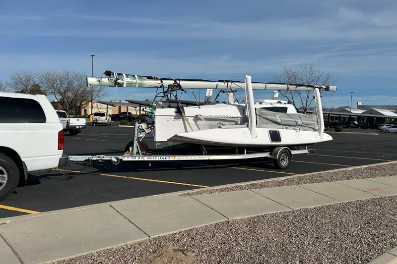 Slide: The Image of Corsair Dash 750MKII 2015 sailboat on trailer, parked in a lot, clear sky. - 11