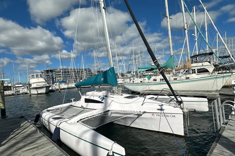 Slide: The Image of 2015 Corsair Dash 750MKII trimaran docked at a marina under a blue sky. - 5