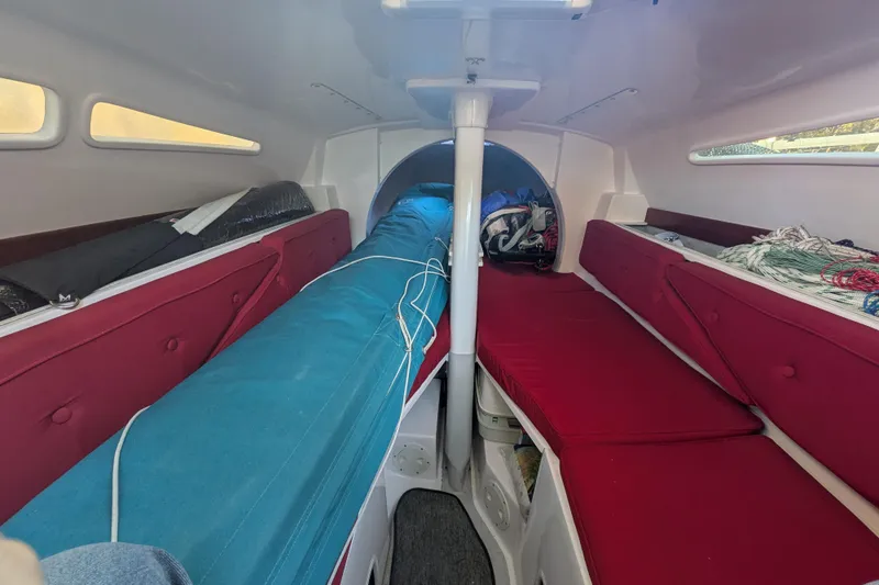 Slide: The Image of Interior of 2015 Corsair Dash 750MKII sailboat with red seating and storage. - 7