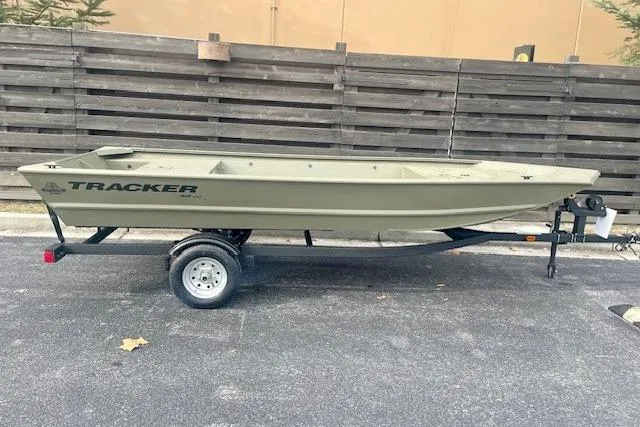 The Image of 2026 Tracker Grizzly 1648 Utility boat on trailer, parked outdoors. - 0