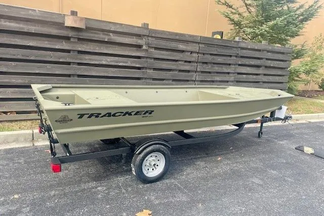Slide: The Image of 2026 Tracker Grizzly 1648 Utility boat on trailer, parked outdoors. - 2
