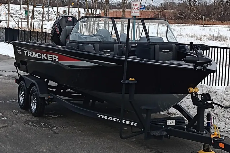 Slide: The Image of 2026 Tracker Targa V-19 Combo boat on trailer in snowy setting. - 2