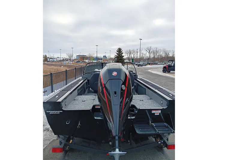 Slide: The Image of 2026 Tracker Targa V-19 Combo boat with powerful outboard motor, parked outdoors. - 5