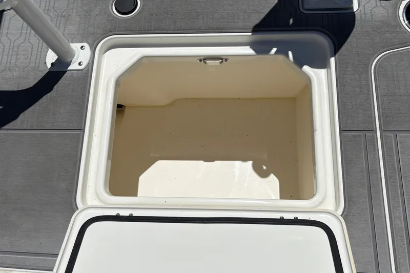 Slide: The Image of Open storage compartment on 2026 Mako 18 Pro Skiff boat deck. - 27