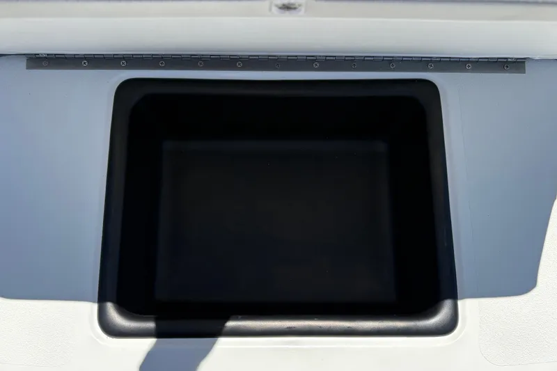 Slide: The Image of Storage compartment of 2026 Mako 18 Pro Skiff boat, open and empty. - 18