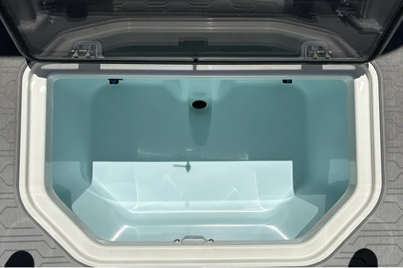 Slide: The Image of An open storage compartment on a Mako 18 Pro Skiff boat, showing a clean, empty interior. - 21