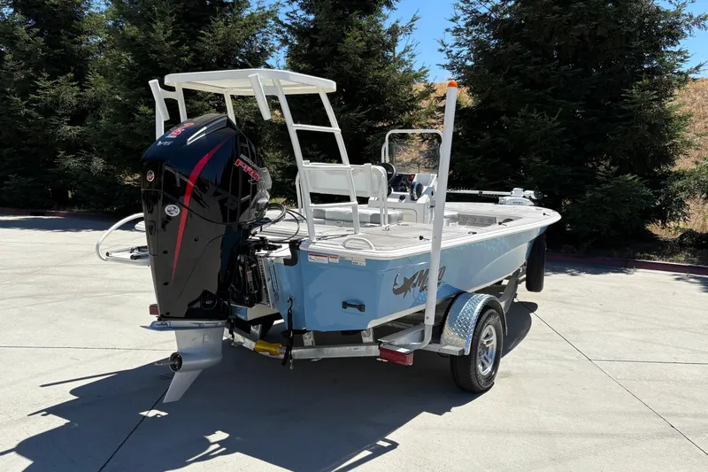 Slide: The Image of 2026 Mako 18 Pro Skiff boat on trailer, parked outdoors. - 9