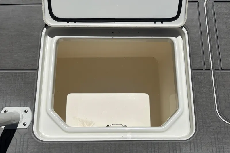 Slide: The Image of Open storage compartment on 2026 Mako 18 Pro Skiff boat deck. - 26