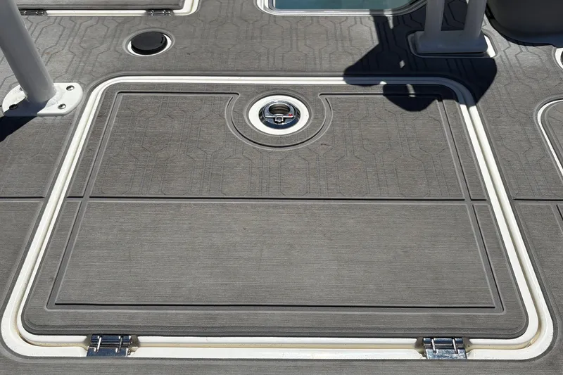 Slide: The Image of Deck of 2026 Mako 18 Pro Skiff with hatch and textured surface. - 33