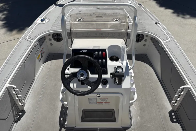 Slide: The Image of 2026 Mako 18 Pro Skiff boat interior with steering console and controls. - 16