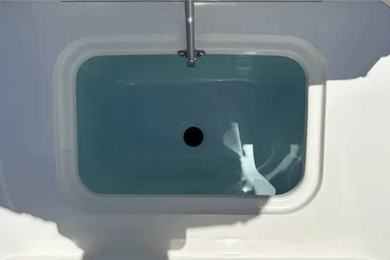Slide: The Image of Livewell of 2026 Mako 18 Pro Skiff boat, filled with water. - 19