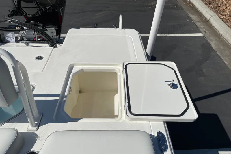 Slide: The Image of Open storage compartment on 2026 Mako 18 Pro Skiff boat deck. - 9