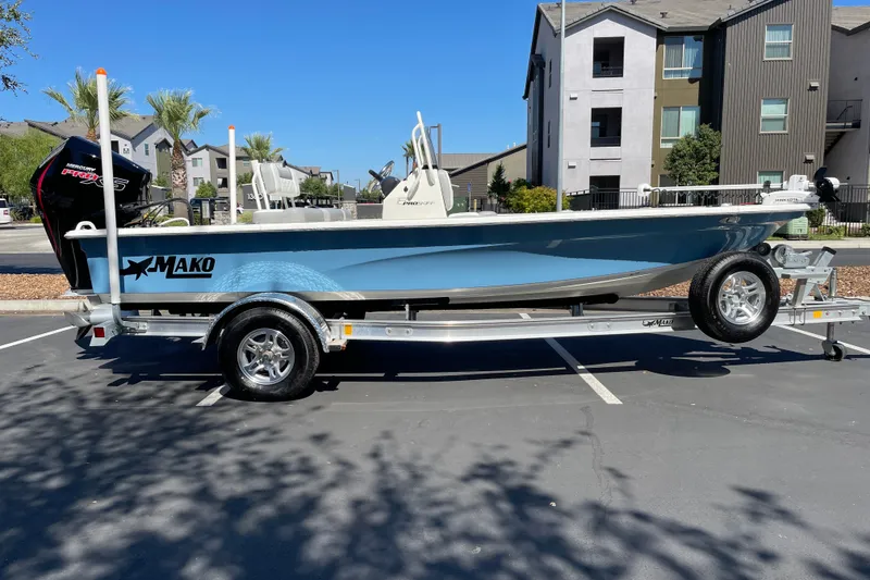 The Image of 2026 Mako 18 Pro Skiff boat on trailer in parking lot, sunny day. - 0