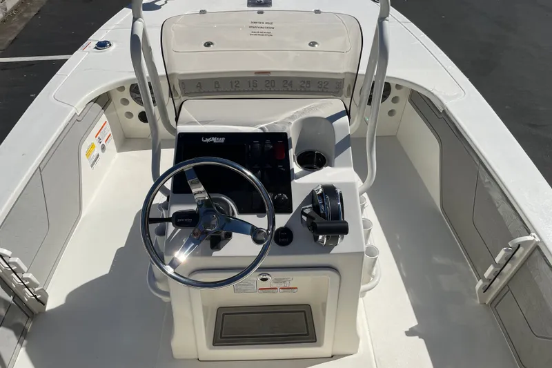 Slide: The Image of 2026 Mako 18 Pro Skiff boat interior with steering wheel and control panel. - 5