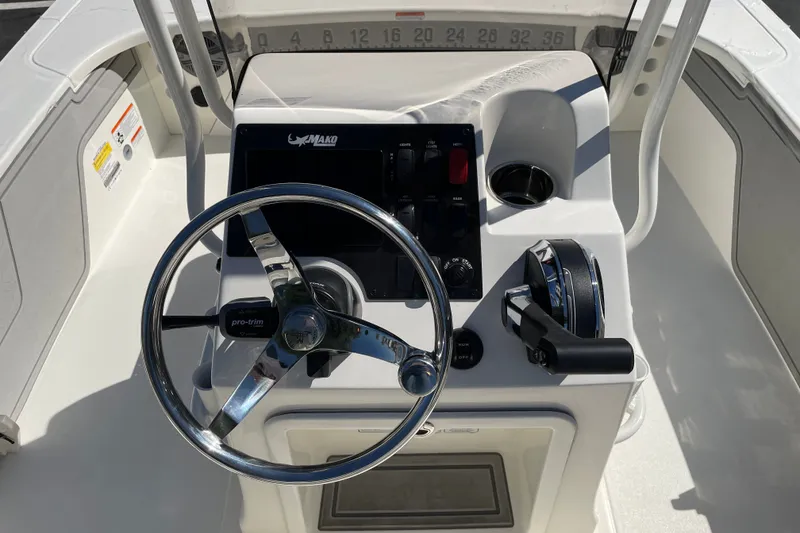 Slide: The Image of 2026 Mako 18 Pro Skiff boat console with steering wheel and controls. - 23
