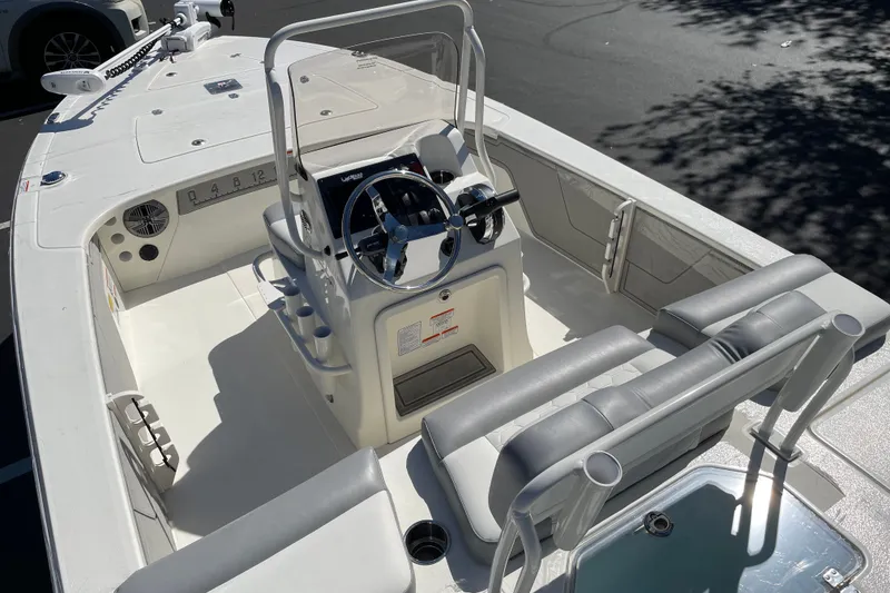 Slide: The Image of 2026 Mako 18 Pro Skiff boat interior with steering console and seating. - 4