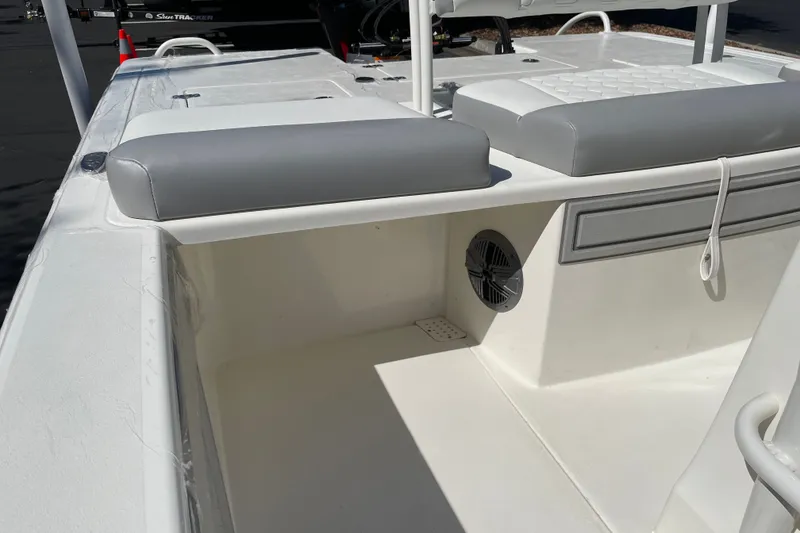 Slide: The Image of 2026 Mako 18 Pro Skiff interior with gray seating and speaker detail. - 17