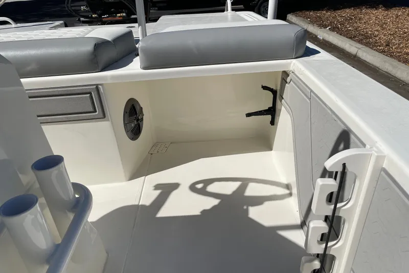 Slide: The Image of 2026 Mako 18 Pro Skiff interior with seating, steering wheel, and storage compartments. - 18
