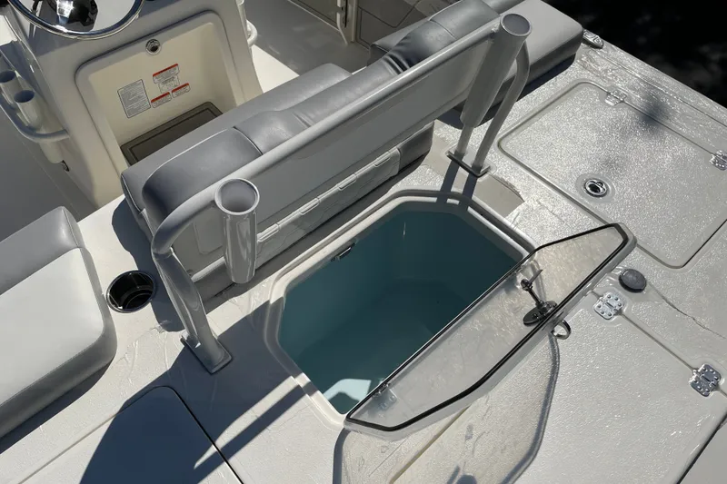 Slide: The Image of 2026 Mako 18 Pro Skiff interior with open storage compartment and seating. - 13