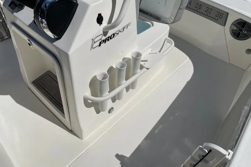 Slide: The Image of 2026 Mako 18 Pro Skiff boat interior with rod holders and control panel. - 15