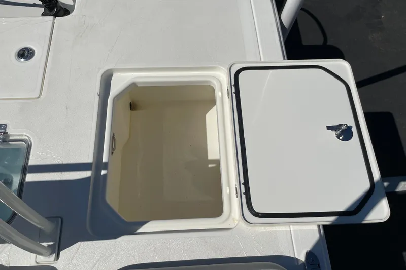 Slide: The Image of Open storage compartment on 2026 Mako 18 Pro Skiff boat deck. - 10