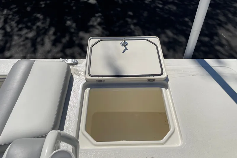 Slide: The Image of Open storage compartment on 2026 Mako 18 Pro Skiff boat deck. - 12