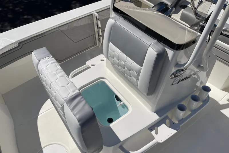 Slide: The Image of 2026 Mako 18 Pro Skiff boat interior with seating and storage compartments. - 8
