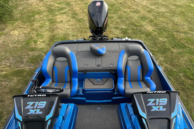 Slide: The Image of 2026 Nitro Z19 XL boat interior with dual seats and motor, on grassy background. - 4